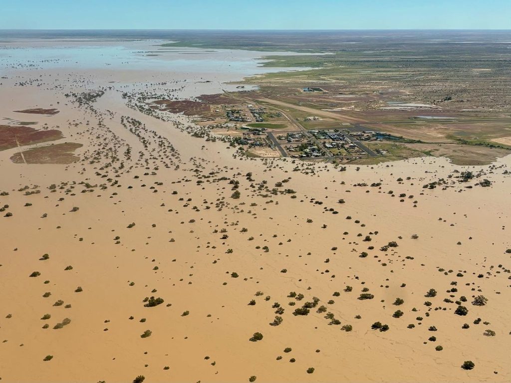 Dirty floodwater surrounds the outback town of Birdsville and stretches as far as the eye can see.